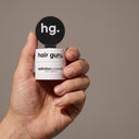 Definition powder held in one hand to show its pocket size