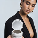 Woman holding the open definition powder compact